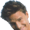 A pixelated image of a person with dark hair and light skin, partially cropped on the left side, next to green text reading 'geocities.com' on a gray background.