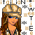 Pixel art contact sheet showing two identical frames of a female character with long brown hair wearing a beige cap and plaid shirt, surrounded by repeating text patterns and checkered symbols on white background.