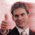 Pixelated image of a person in dark suit and white shirt giving two thumbs up against pink background with white dots.