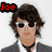 A pixelated image of a person with dark hair and sunglasses, wearing a gray jacket over a white shirt and black choker necklace.