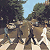 Pixelated static image of two figures walking outdoors with trees and sky background, likely a low-resolution buddy icon from early internet era.
