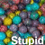 A static image with a dense pattern of multicolored circular shapes and overlaid white text fragments.