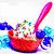 Two red bowls filled with colorful pixelated toppings, each with a pink spoon, under a pink 'Tash' text box on a white background.