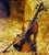 Static pixelated image of a cello against a gradient background transitioning from dark brown to golden yellow.