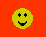 Two yellow pixelated smiley faces on a red background; left face has solid black eyes and mouth, right face has closed eyes with horizontal lines and tongue sticking out.