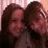 Two people with long brown hair smiling closely together on a red background with pixelated text reading BEST FRIENDS FOREVER.