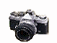 A digital camera icon with a white flash effect on the lens, transitioning to a yellow X mark over the lens, and finally a teal map of Australia with a small camera icon on it.