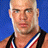 Pixelated portrait of a person with short light hair wearing a dark sleeveless top and red-white-blue striped lanyard against solid blue background.