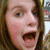 A four- of a person with light brown hair and open mouth, each displaying different pixelated text overlays