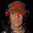 A pixelated image of a person wearing a camouflage cap with red text reading 'life illusion' above the head, transitioning to 'is' and then 'an'