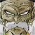 Pixelated close-up of a face with narrowed eyes, a wide nose, and a mouth showing teeth, rendered in muted brown and gray tones.