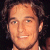 Static pixelated image of a person's face with dark hair and light skin tone, displayed as a 50x50 buddy icon on a black background.