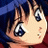 Pixelated close-up of an anime-style character's face with dark blue hair, large expressive eyes, and a slightly open mouth against a gradient background.