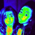 Two pixelated green cartoon heads with blue outlines and yellow accents on dark purple background.