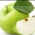 A green apple with a leaf and stem, partially sliced to reveal white flesh and brown core.