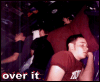 A person in a maroon shirt rests their head on a hand against a dark background with red pillows, while text overlays change from 'over it' to 'shop sell' and 'I'll watch your sleep.'
