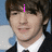 A pixelated image of a person in a black suit and white shirt with pink text overlays reading 'i', 'love', and 'drake bell' across different sections.