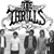 Pixelated black-and-white static image featuring stylized text "THE THRILLS" above a group of silhouetted figures in various poses against a white background.