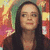 A woman with long dark hair appears in three distinct poses against a colorful abstract background, each showing different facial expressions and head angles.