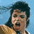 Pixelated image of a person with dark hair against light blue background, wearing brown garment.