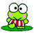 Two side-by-side pixel art frames of a green frog character with large white eyes, pink cheeks, and red-and-white striped shorts standing on a lily pad against a gray background.