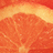 A static close-up of a sliced citrus fruit with segmented orange flesh and visible pith, presented in four quadrants.