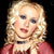 Static pixelated image of a person with blonde hair wearing a red top against dark background