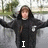 A person in a black hoodie with arms outstretched against a blurred outdoor background, displaying text changes from 'I' to '<33' to 'him!' across frames.