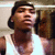 A person in a white tank top and dark cap appears in three showing slight head movement against a blurred background