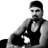 Black-and-white pixelated static image of a person in a sleeveless top with visible facial features and partial body, rendered at low resolution on white background.