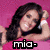 A pixelated image of a person with long dark hair lying on a pink background, wearing a white wristband and blue jeans.