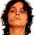 A 50x50 pixel buddy icon featuring a person with dark hair on the left and a black geometric symbol on the right, displayed as a static contact sheet frame.