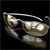 A static pixelated image of a metallic object with curved, reflective surfaces against a black background.