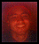 A pixelated portrait of a person with curly red hair smiling, displayed in two side-by-side frames with subtle facial expression changes.