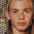 Four distinct headshots of a young man with varying hair lengths and styles arranged in a against a checkered background