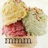 A close-up of three scoops of ice cream in a bowl with the text 'mmm' below.