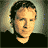 Pixelated portrait of a person with short dark hair against a gradient background, next to blue text reading 'brian' on light sky-like backdrop.