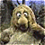 A pixelated contact sheet showing two frames of an animated icon featuring a Fraggle Rock character on the left and green text reading "Original Icons .com" on the right against a dark background.
