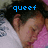 Pixelated image of a person with dark hair wearing white and pink clothing, blue text reading 'queef' overlaid at the top.
