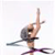 Pixelated static image of a gymnast performing on a balance beam with arms raised and legs extended in a split pose, wearing a dark leotard with purple accents against a white background.