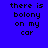 Blue background with black pixelated text reading 'there is bolony on my car' and orange rectangular overlays in various positions across the image.