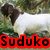 A pixelated image of a sheep with dark brown wool on its head and legs, standing in front of green foliage. The word "Suduko" appears below the animal.