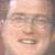A 2x2 contact sheet of four animated frames showing a person with glasses in various facial expressions against a gray background.
