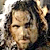 Pixelated close-up of a person with dark curly hair and closed eyes, rendered in warm tones against a light background.