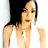 Pixelated static image of a person with dark hair wearing a black top and white garment, cropped to show upper body against light background.