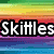 A static image with rainbow striped background and bold white text reading "Skittles See the Rainbow Taste the Rainbow" in four segments.