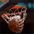 Pixelated static icon of a basketball with orange and brown tones, featuring visible pixelation artifacts and partial black lines suggesting seams or text.