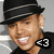 A pixelated image of a person wearing a black hat with white stripes, smiling widely while displaying teeth, with an orange text overlay reading "Just Call Me..." and "Mrs. Brown" on dark brown backgrounds.