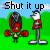 Pixelated static image featuring two red and brown objects on a green background with "Shut it up" text at the top.
