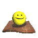 Yellow spherical smiley face on brown textured base with dark circular indentation, shown in four sequential positions from top to bottom.
